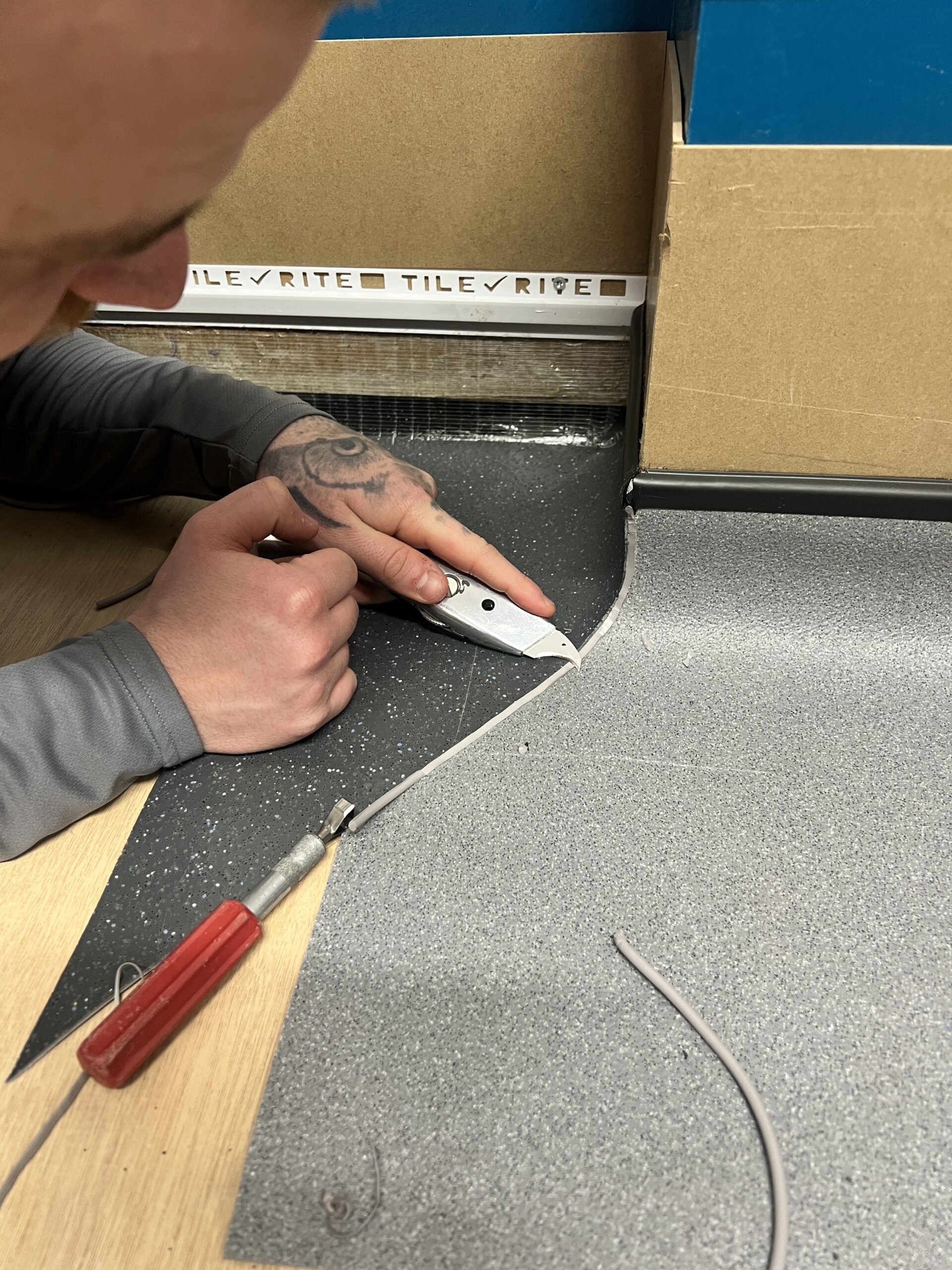 Young trainee floor layer on a flooring course practising his external welds 
